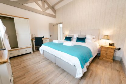 A super-king-size bedroom at Malbank Barn, Cheshire