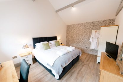 A super-king-size bedroom at Malbank Barn, Cheshire