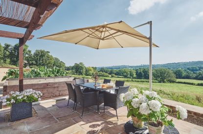 The outdoor dining table and view at Horseshoe House, Peak District