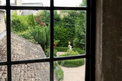 A view into the private garden from the window at Wild Rose Cottage, Cotswolds