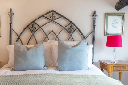 Soft furnishings on a double bed at Wild Rose Cottage, Cotswolds