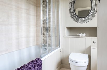 The shared bathroom on the first floor with a shower over the bath at Wild Rose Cottage, Cotswolds