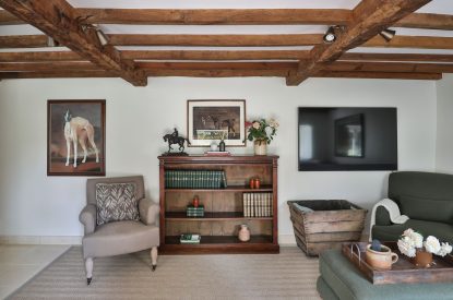 A reading corner in the living room at Rambling Rose Cottage, Cotswolds