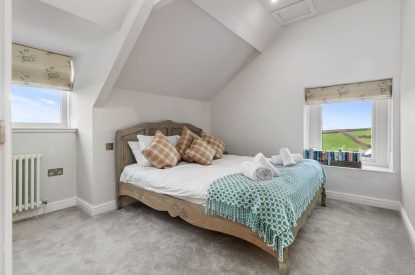 A king size bedroom at Channel View, Oxwich