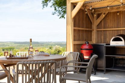 Outdoor kitchen and dining area at Woodlark, Devon